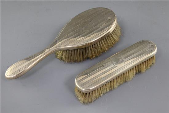 Two George V silver engine turned dressing table brushes.